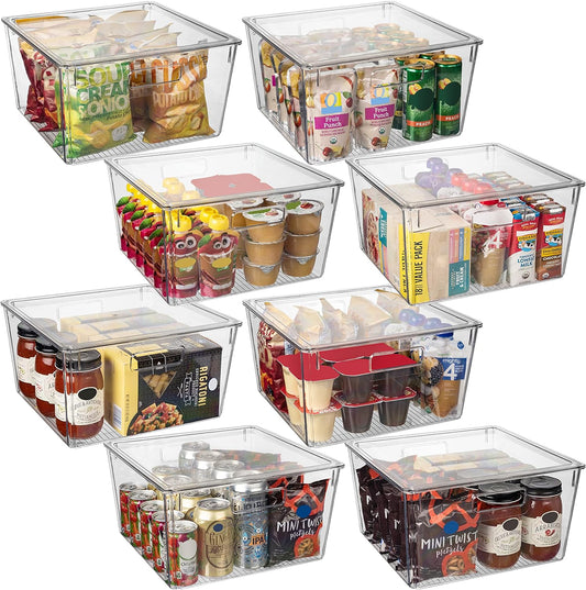 Clear storage bins with food items on a white background