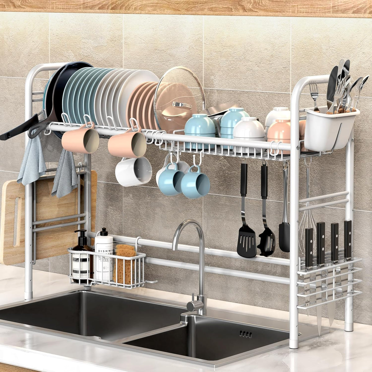 Kitchen sink rack with utensils, mugs, and cookware against a tiled wall.