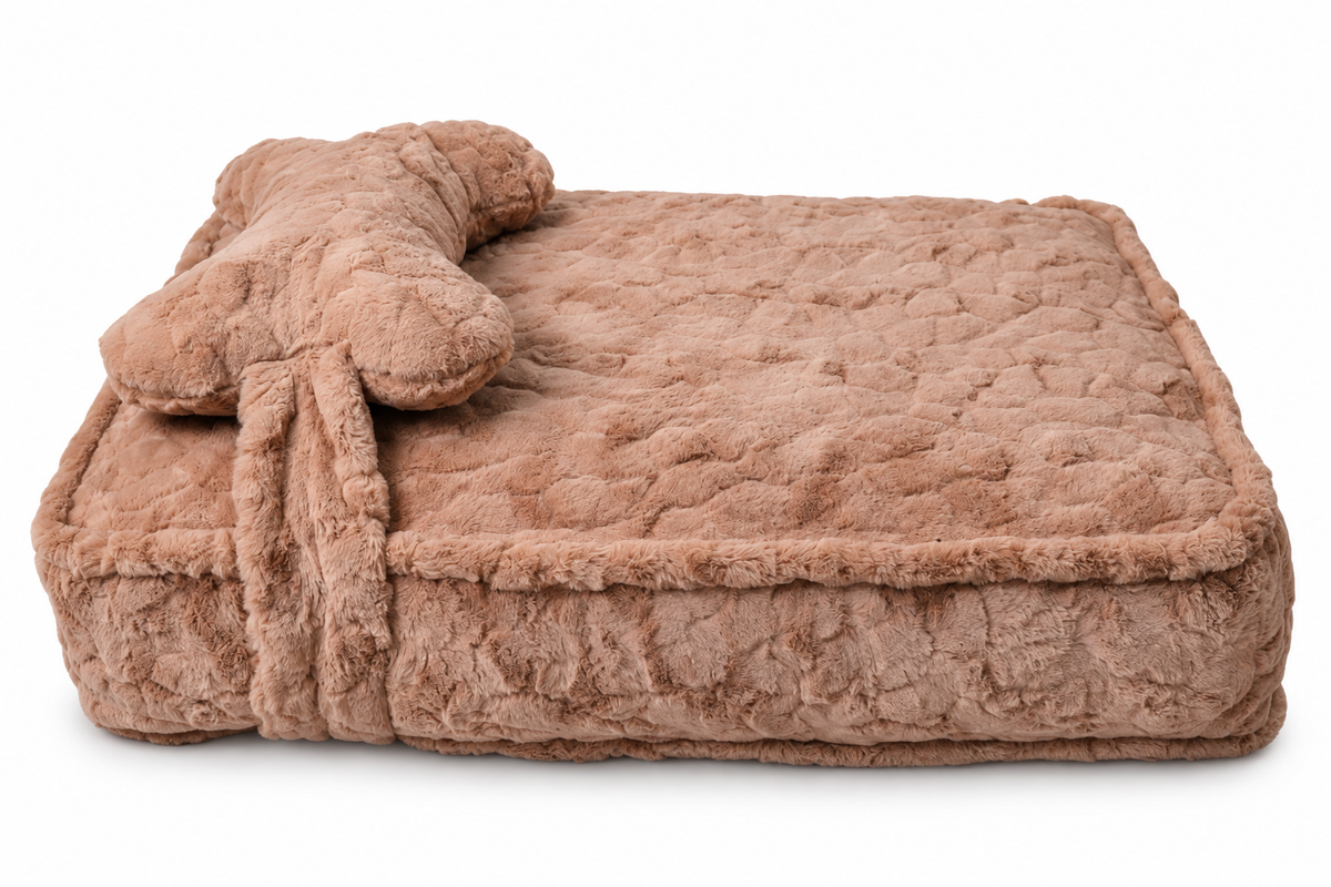 A plush, quilted rectangular pet bed in a warm taupe-brown color, featuring a matching bone-shaped cushion resting on top, set against a plain white background.